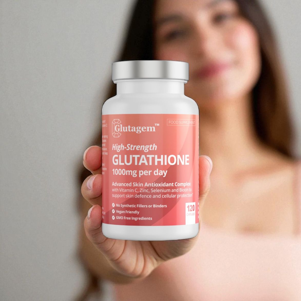 Woman holding a Glutagem Glutathione 120 Capsules bottle, a 250mg reduced glutathione supplement supporting skin brightening and antioxidant care.